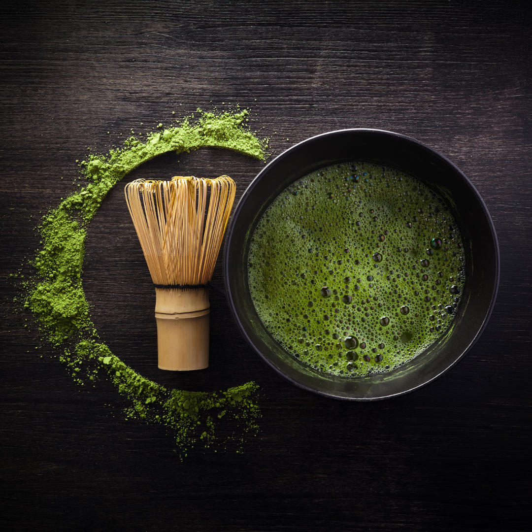 A traditional Japanese tea set, including a matcha bowl, whisk, and powdered green tea; PC: vetrestudio