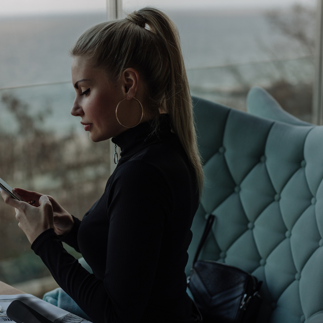 woman using phone with vaporizer technology 